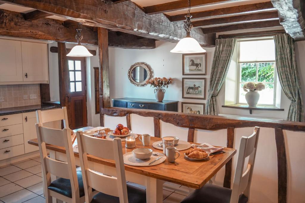 Beamed farmhouse kitchen with long oak table